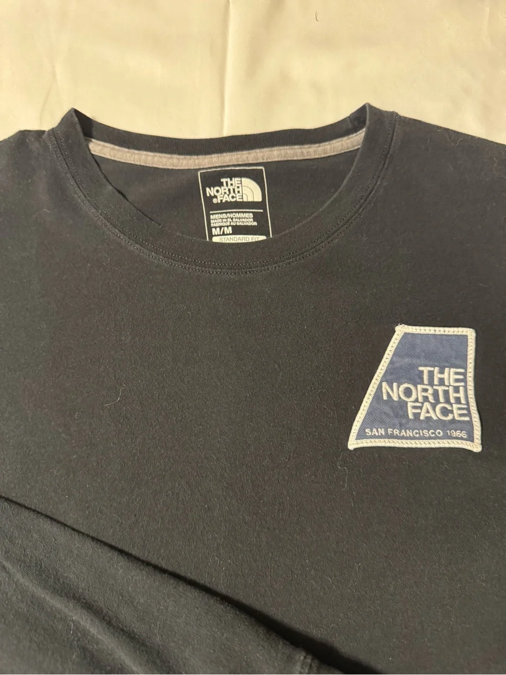 The North Face Black Long Sleeve Tee with Blue Logo Patch